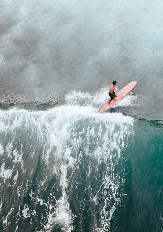 Surfer riding a powerful wave at a Portugal surf retreat